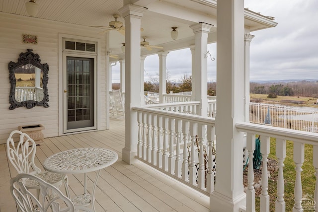 wooden terrace featuring ceiling fan and covered porch