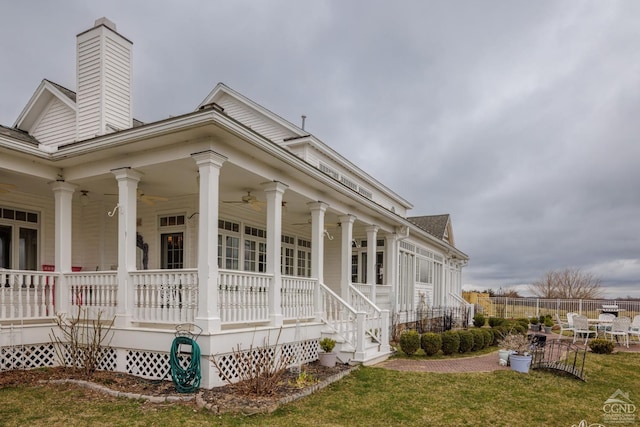 view of property exterior featuring a porch and a yard