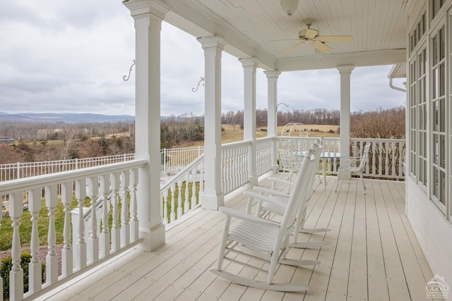 wooden deck featuring a porch and ceiling fan