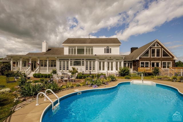 view of pool with french doors and a patio