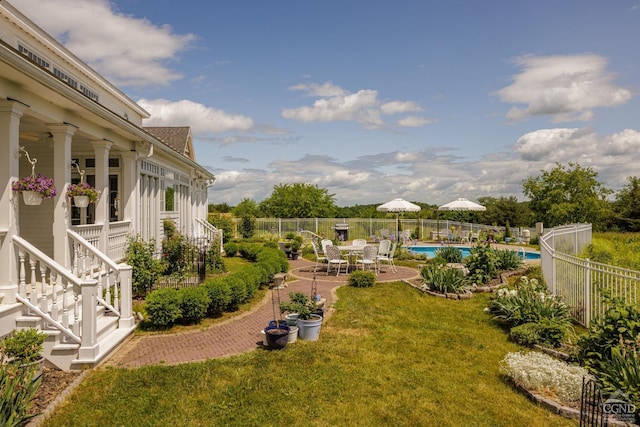 view of yard featuring a fenced in pool and a patio