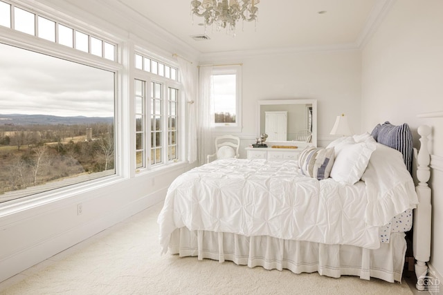 carpeted bedroom with crown molding and a chandelier