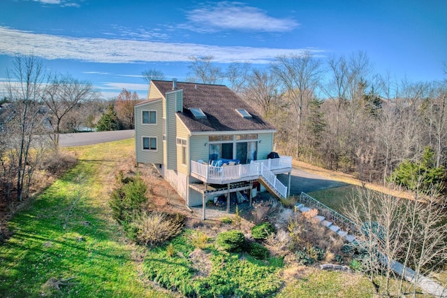 back of house with a yard and a wooden deck