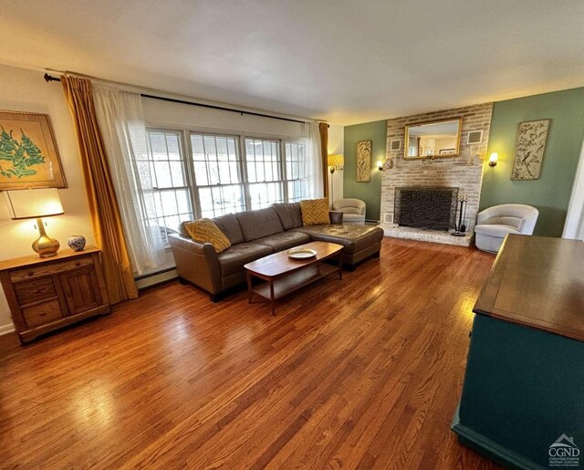 living room featuring a brick fireplace and dark hardwood / wood-style floors