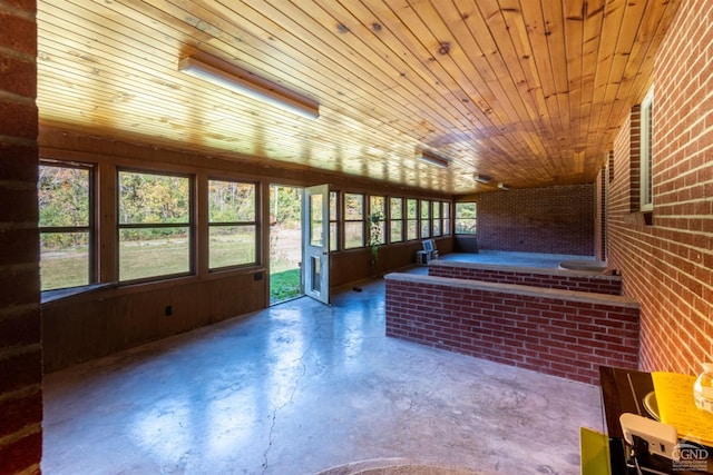 unfurnished sunroom with a wealth of natural light and wood ceiling