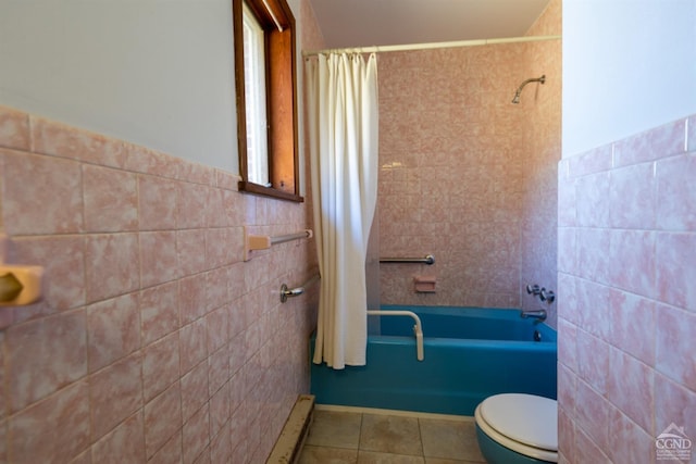 bathroom with a baseboard heating unit, tile patterned floors, shower / bath combination with curtain, toilet, and tile walls