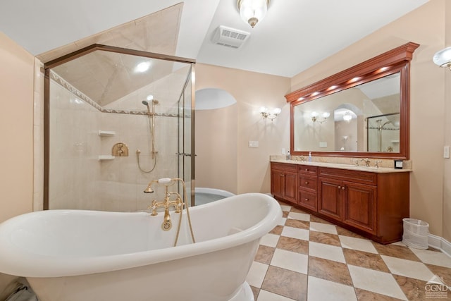 full bath with double vanity, visible vents, a freestanding bath, a sink, and a shower stall