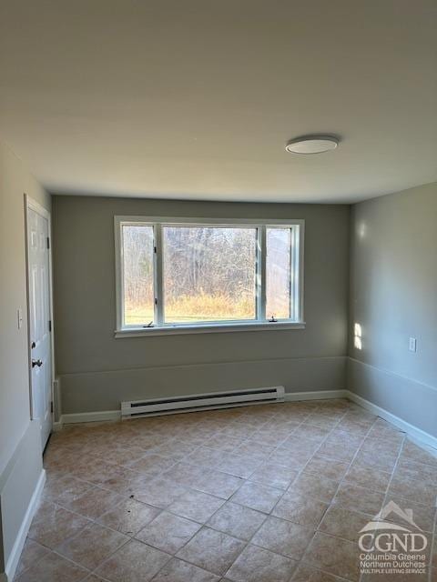 empty room featuring a healthy amount of sunlight and a baseboard radiator