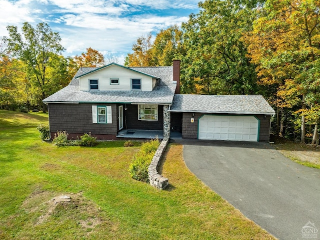 view of front of home featuring a porch, a garage, and a front lawn