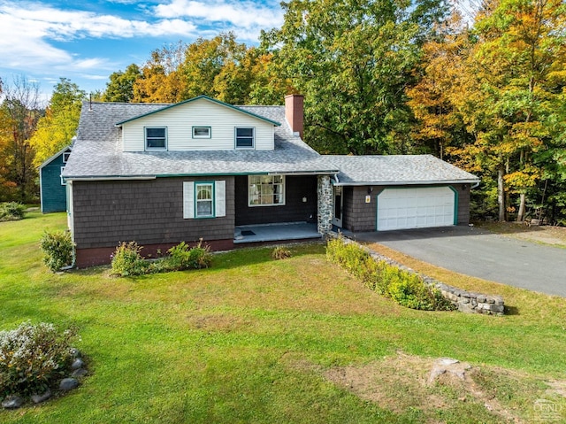 view of front of house with a garage and a front lawn