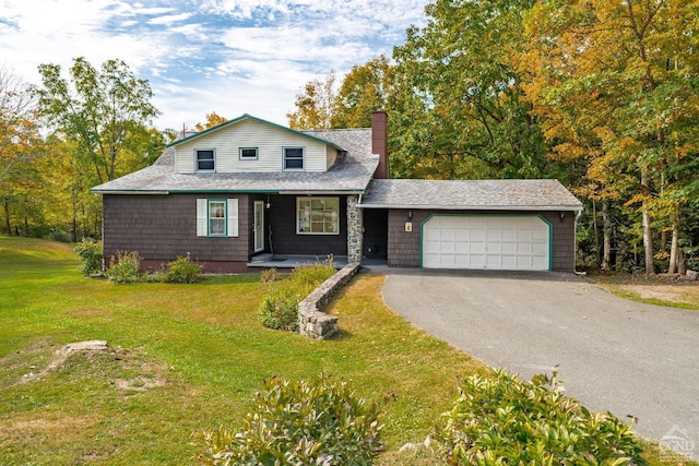 view of front of property featuring a garage and a front yard