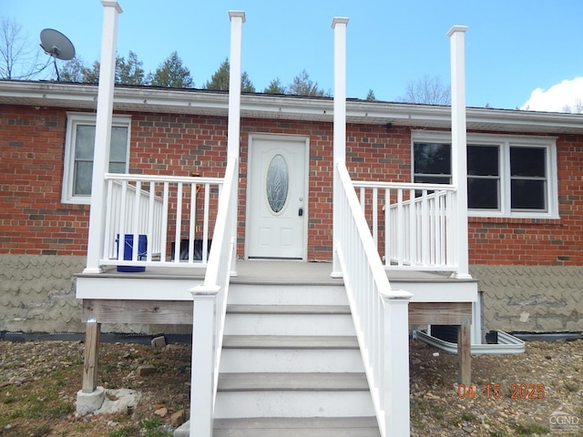 view of exterior entry with brick siding