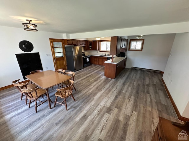 dining area with baseboards and dark wood-style flooring