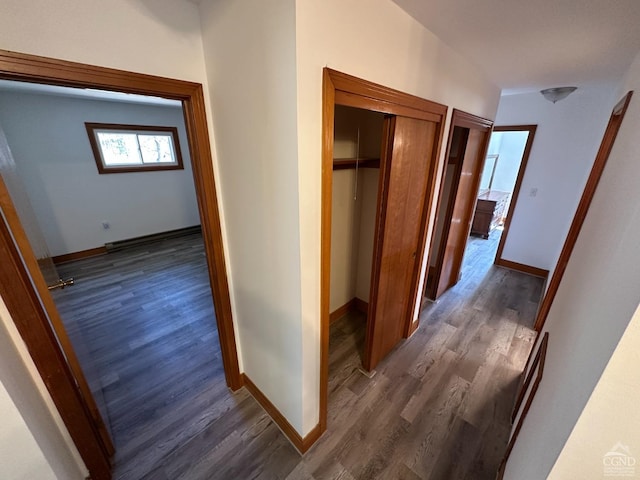 hall with baseboards and dark wood finished floors