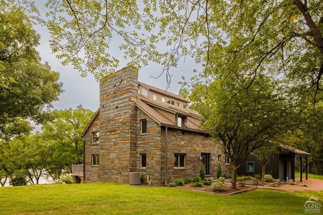 view of home's exterior featuring a yard and central AC