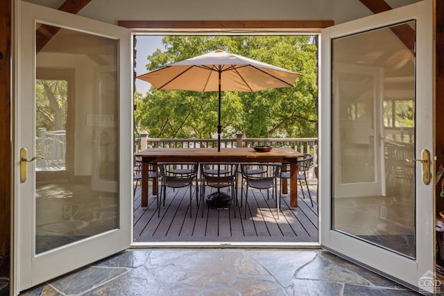 entryway with beamed ceiling and a healthy amount of sunlight