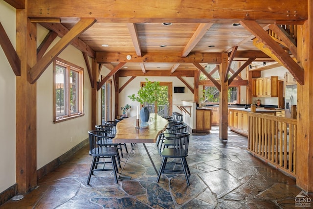 dining room with beam ceiling and wood ceiling