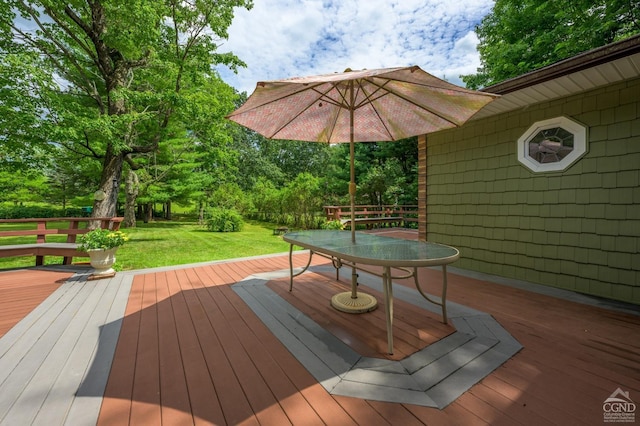 wooden terrace with a lawn