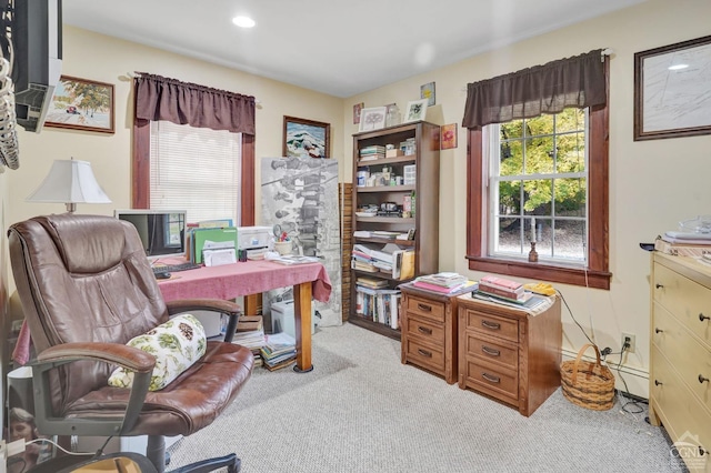 office with light colored carpet and a baseboard heating unit