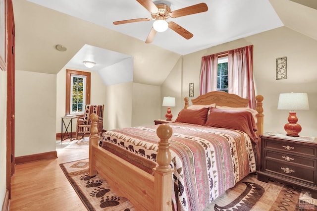 bedroom with light hardwood / wood-style floors, vaulted ceiling, and ceiling fan