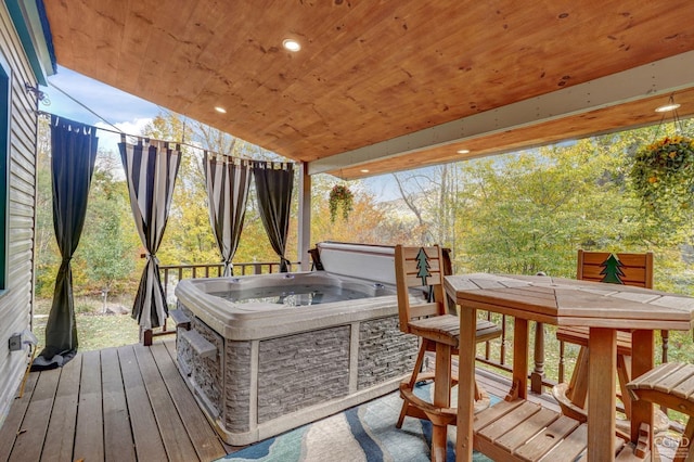 wooden deck with a hot tub