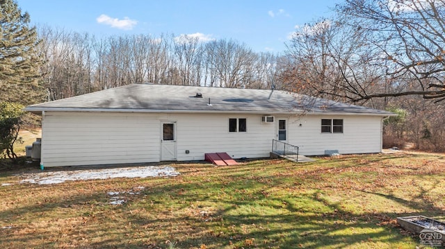 rear view of property featuring a yard