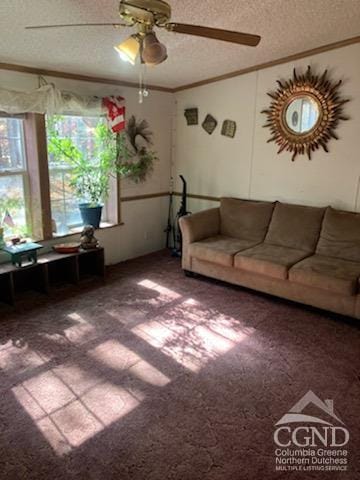 unfurnished living room with carpet, ceiling fan, ornamental molding, and a textured ceiling