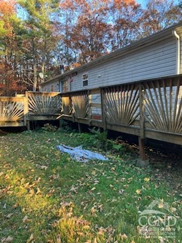 rear view of property featuring a deck