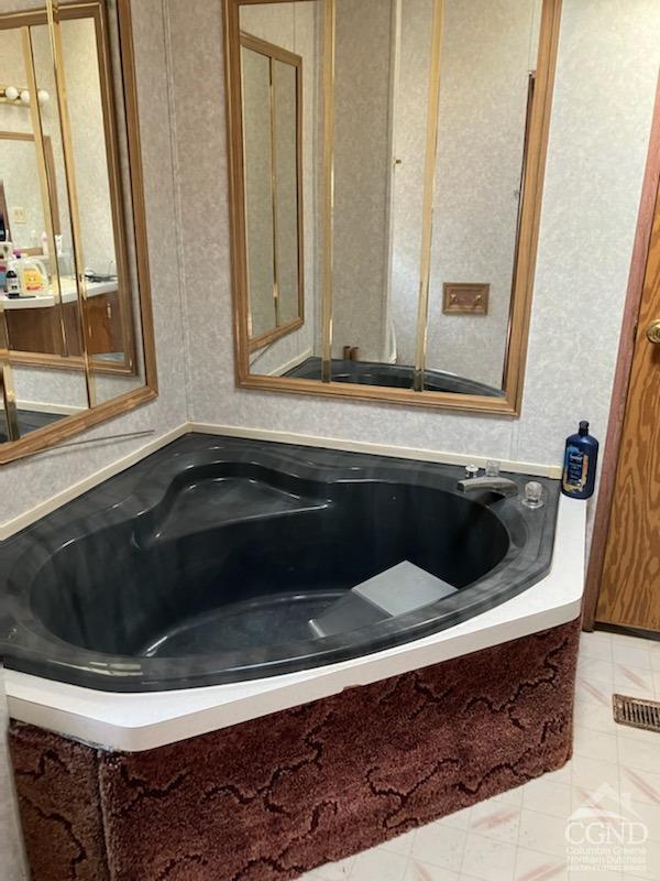 bathroom featuring tile patterned flooring and a bathing tub