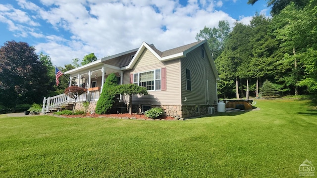 view of property exterior with a lawn and a porch