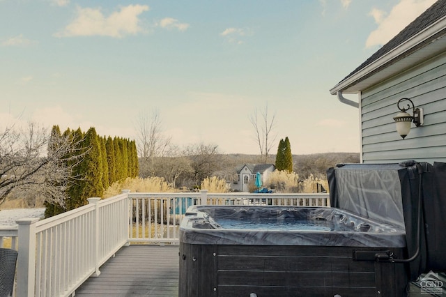 wooden deck with a hot tub