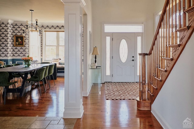 entrance foyer with stairs, decorative columns, and a healthy amount of sunlight