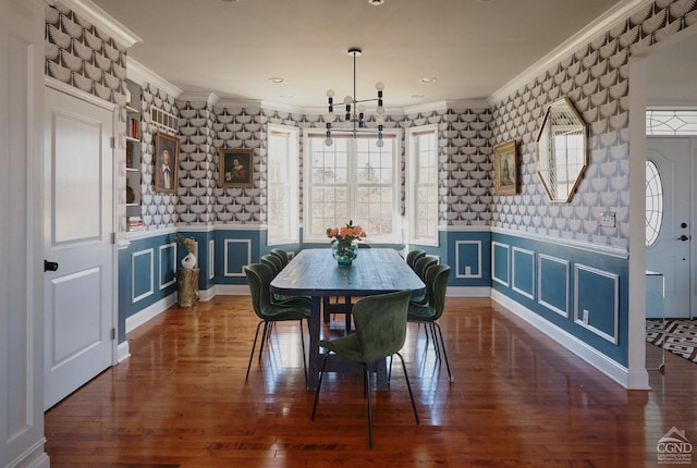 dining room featuring crown molding, wallpapered walls, and an inviting chandelier