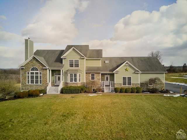 view of front of house featuring a chimney, a front lawn, and stone siding