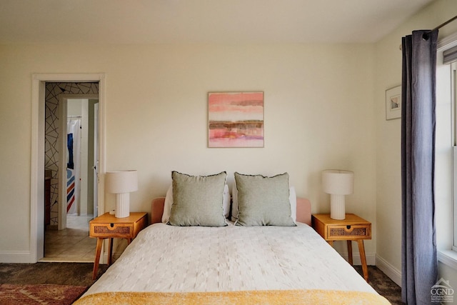 bedroom with baseboards and multiple windows