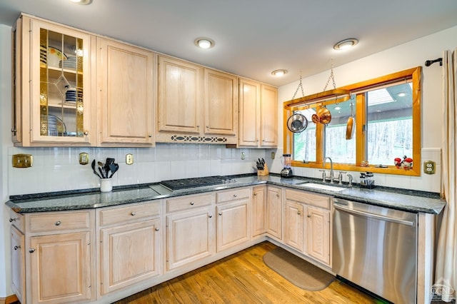 kitchen featuring light brown cabinets, light wood-type flooring, stainless steel appliances, and sink