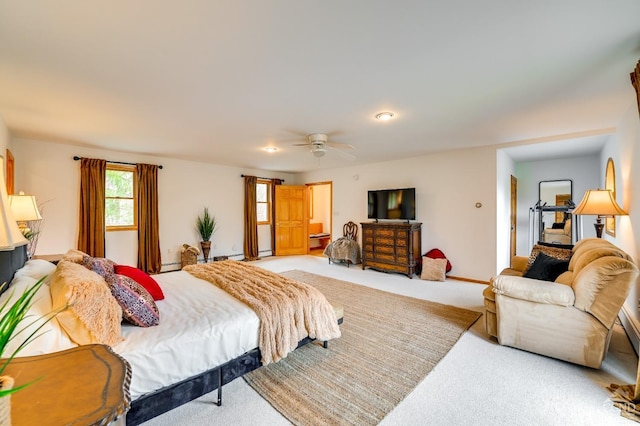 carpeted bedroom with baseboard heating and ceiling fan