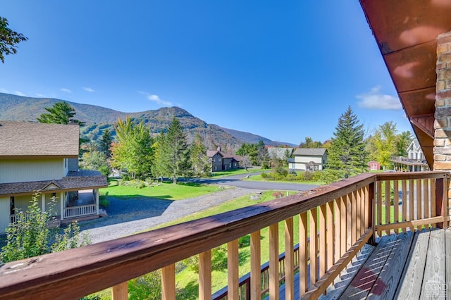 deck with a lawn and a mountain view