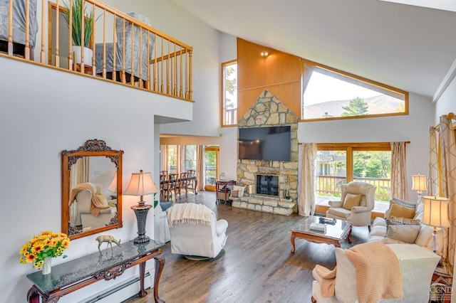 living room featuring a fireplace, plenty of natural light, high vaulted ceiling, and wood-type flooring