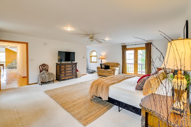 bedroom featuring access to exterior, light carpet, french doors, and ceiling fan