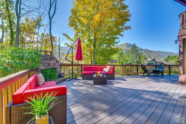 deck with a mountain view and an outdoor hangout area