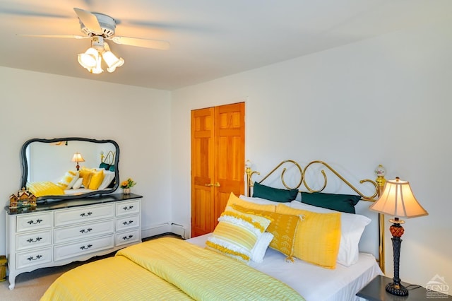 bedroom featuring carpet, ceiling fan, a baseboard radiator, and a closet