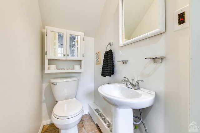 bathroom with a baseboard radiator and toilet