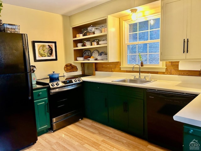 kitchen with green cabinetry, light hardwood / wood-style floors, black appliances, built in shelves, and sink