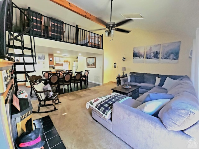 carpeted living area featuring beam ceiling, baseboards, and a ceiling fan