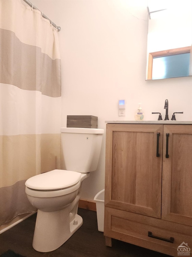 full bathroom with vanity, a shower with curtain, toilet, and wood finished floors