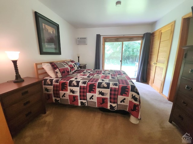 carpeted bedroom with a wall mounted air conditioner, a closet, and access to outside