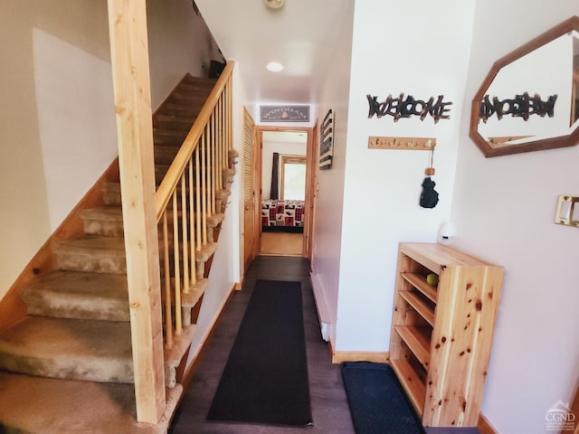 staircase featuring baseboards