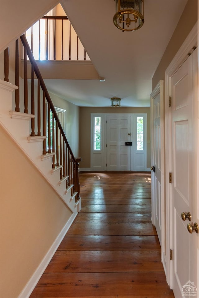 entrance foyer with plenty of natural light and dark wood-type flooring