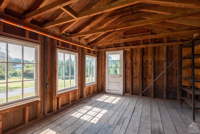 miscellaneous room featuring hardwood / wood-style floors and lofted ceiling